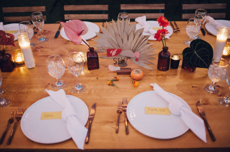 The wedding tablescapes were done with boho and desert touches, candles and bright blooms