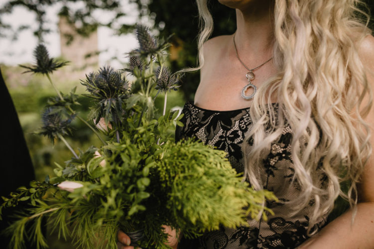 The bride was carrying a simple greenery and thistle wedding bouquet