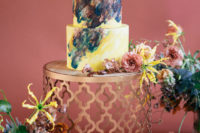 11 The wedding cake was done in bright yellow and decorated with dark and pastel brushstrokes