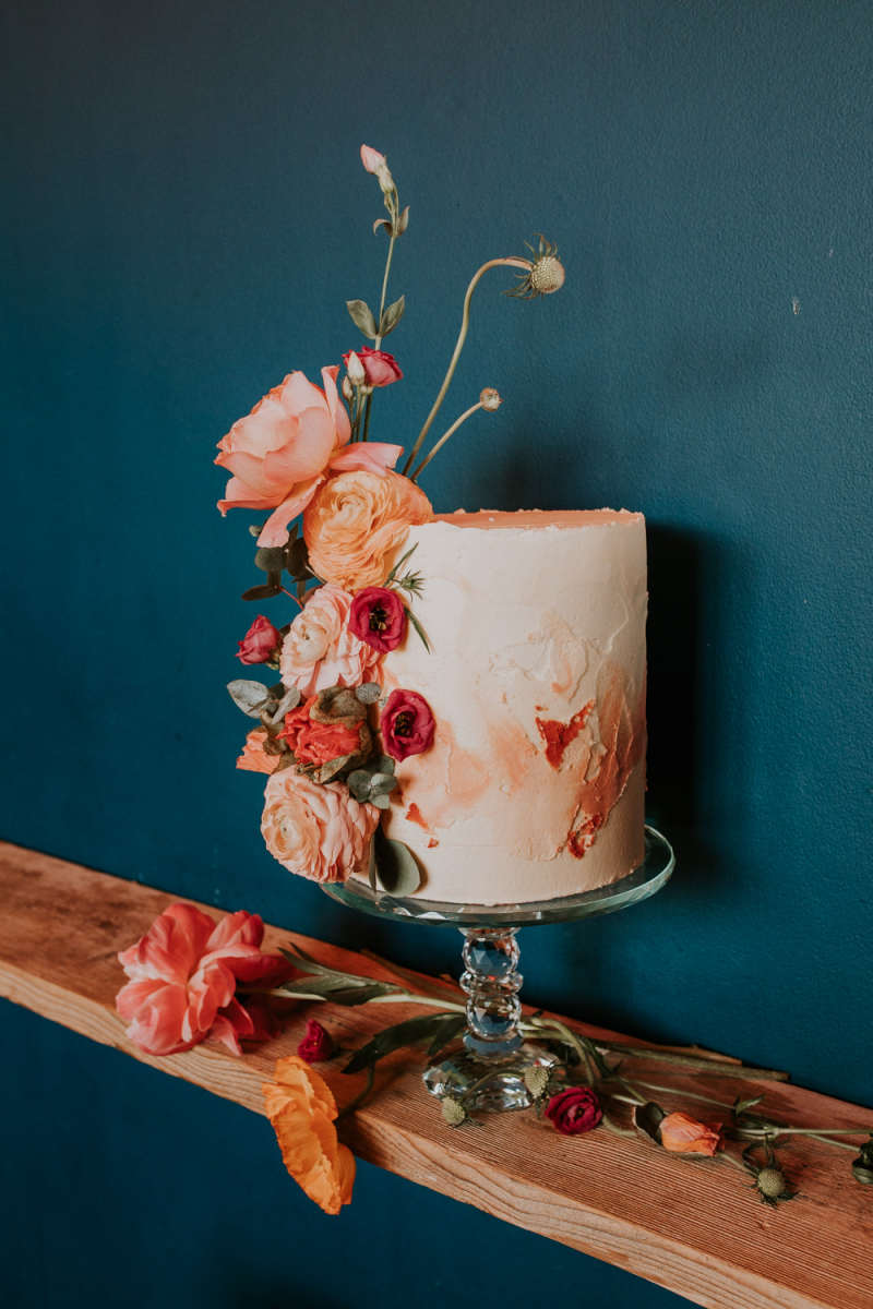 The wedding cake was textural and ombre coral, with fresh coral blooms on its side