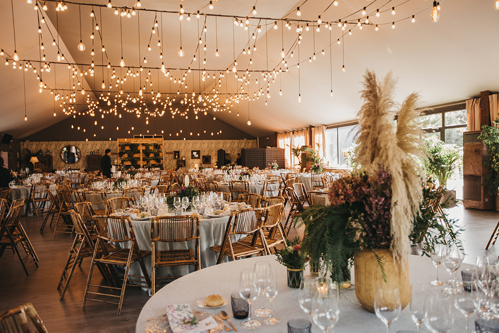 Lots of lights illuminated the wedding venue and rattan chairs completed the simple and cozy look