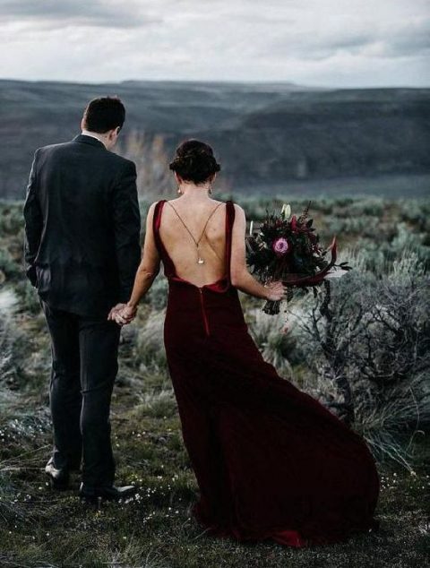 a burgundy velvet wedding dress with a train and a cutout back plus thin straps, a back necklace for a statement