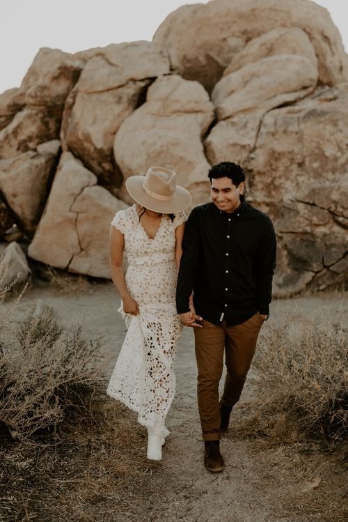 A boho groom's look with a black shirt, rust colored pants and brown shoes is a good idea for a boho or desert wedding