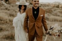 a bold boho groom’s look with a black shirt, a rust pantsuit, a bolo tie and black shoes is a catchy and cool idea for a wedding