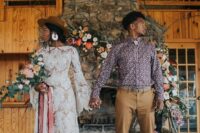 a bright boho groom’s look with a printed purple shirt, tan pants, navy shoes and a bolo tie is a cool and catchy idea