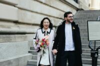 a casual groom’s outfit with a white shirt, black pants, a midi coat and black shoes is a lovely idea for a city hall wedding