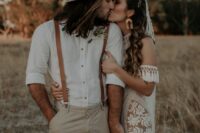 a lovely boho groom’s outfit with a white shirt, grey pants, amber leather suspenders and a grey hat is a cool idea for a wedding