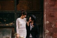 a relaxed groom’s look with a white shirt, blue jeans, black loafers, a black blazer and a hat is a cool idea for a boho wedding
