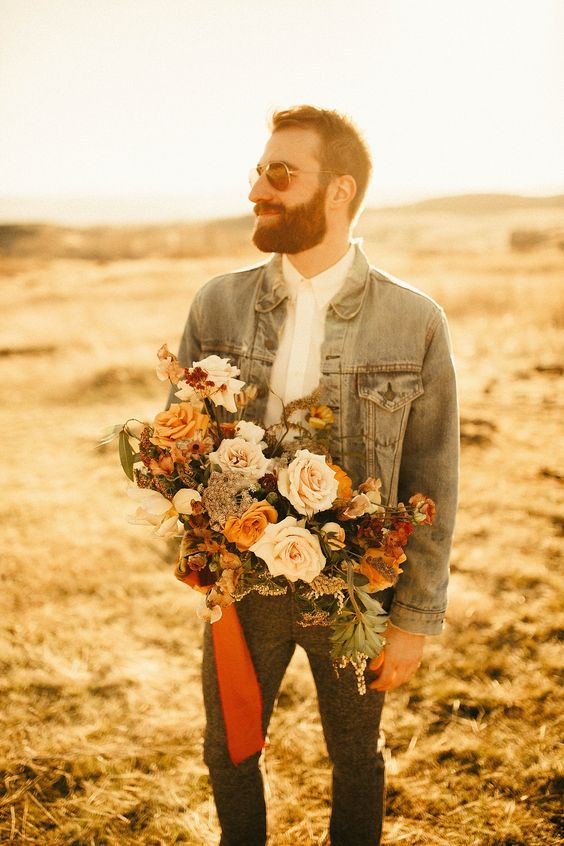 a relaxed groom's outfit with a white shirt, grey pants, a bleached denim jacket and sunglasses is a lovely and cool idea