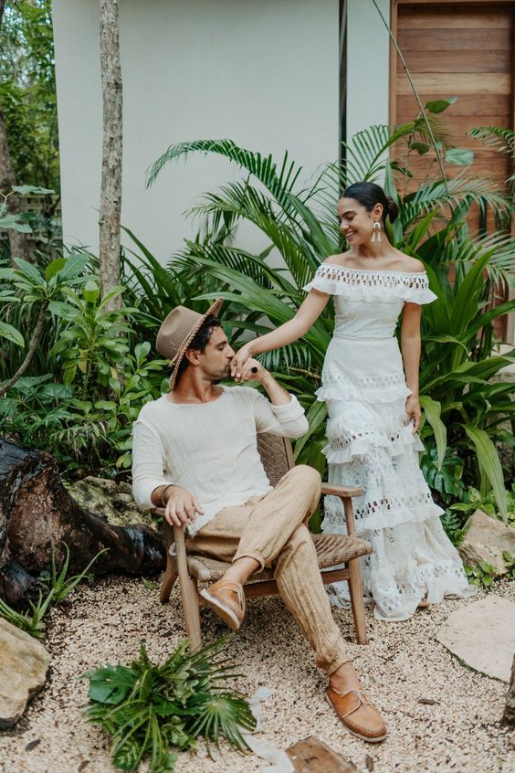 a super relaxed groom's look with a linen long sleeve top, tan pants, brown shoes and a tan hat is a great idea for a tropical wedding