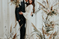 This black and white and muted tones wedding shoot was done with trendy dried flower arrangements