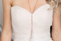 02 The bride was wearing a strapless draped wedding dress and a copper necklace with white tassels