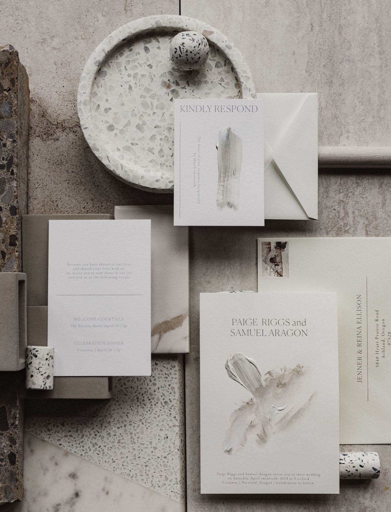 The wedding invitation suite is done in muted and neutral tones, with minimal aesthetics