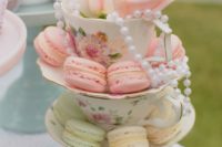 02 a beautiful wedding or bridal shower centerpiece made of vintage teacups, colorful macarons and pearls plus a bloom
