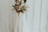 03 The bride was wearing a modern wedding dress with a high neckline, bell sleeves and a train