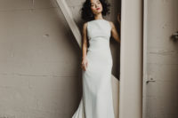 03 The bride was wearing a plain fitting sleeveless wedding dress with a train
