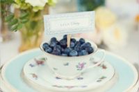 03 a chic vintage-inspired place setting in aqua, with a floral teacup and blueberries inside plus a card