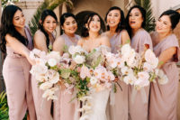 04 The bridesmaids were rocking mismatching mauve dresses and carried beautiful bouquets in blush