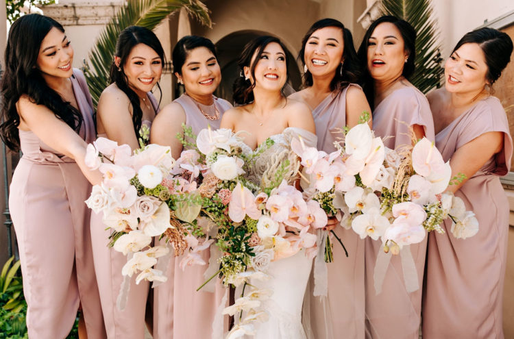 The bridesmaids were rocking mismatching mauve dresses and carried beautiful bouquets in blush