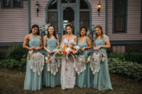 The bridesmaids were wearing mismatching sage green dresses and carrying macrame rings with blooms instead of usual bouquets