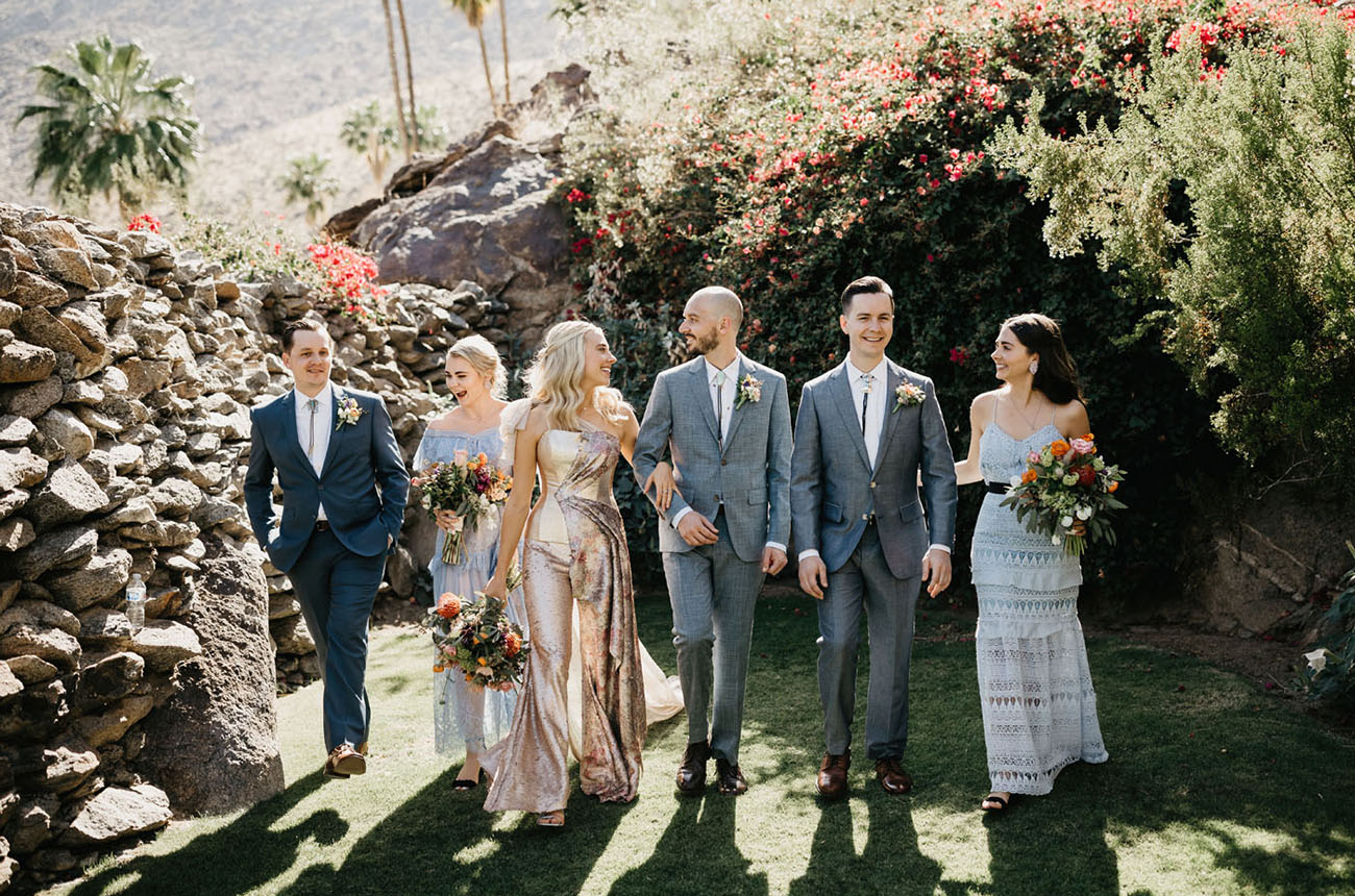 The groomsmen were wearing grey and blue suits, and the bridesmaids were rocking mismatched boho lace gowns