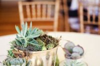 04 a cute wedding centerpiece with a metal bucket with succulents and teacups with them