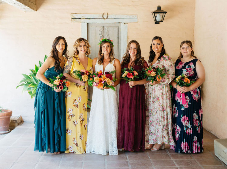 The bridesmaids were wearing mismatched floral and solid dresses