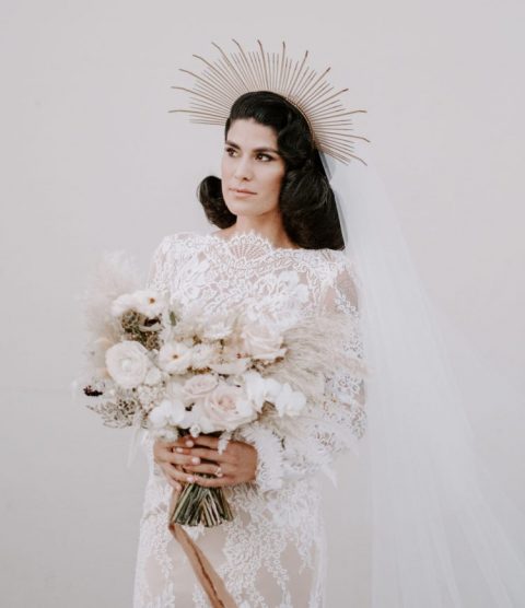 a whimsy sunburst wedding headpiece with a long veil to add a bit of edge to the refined look