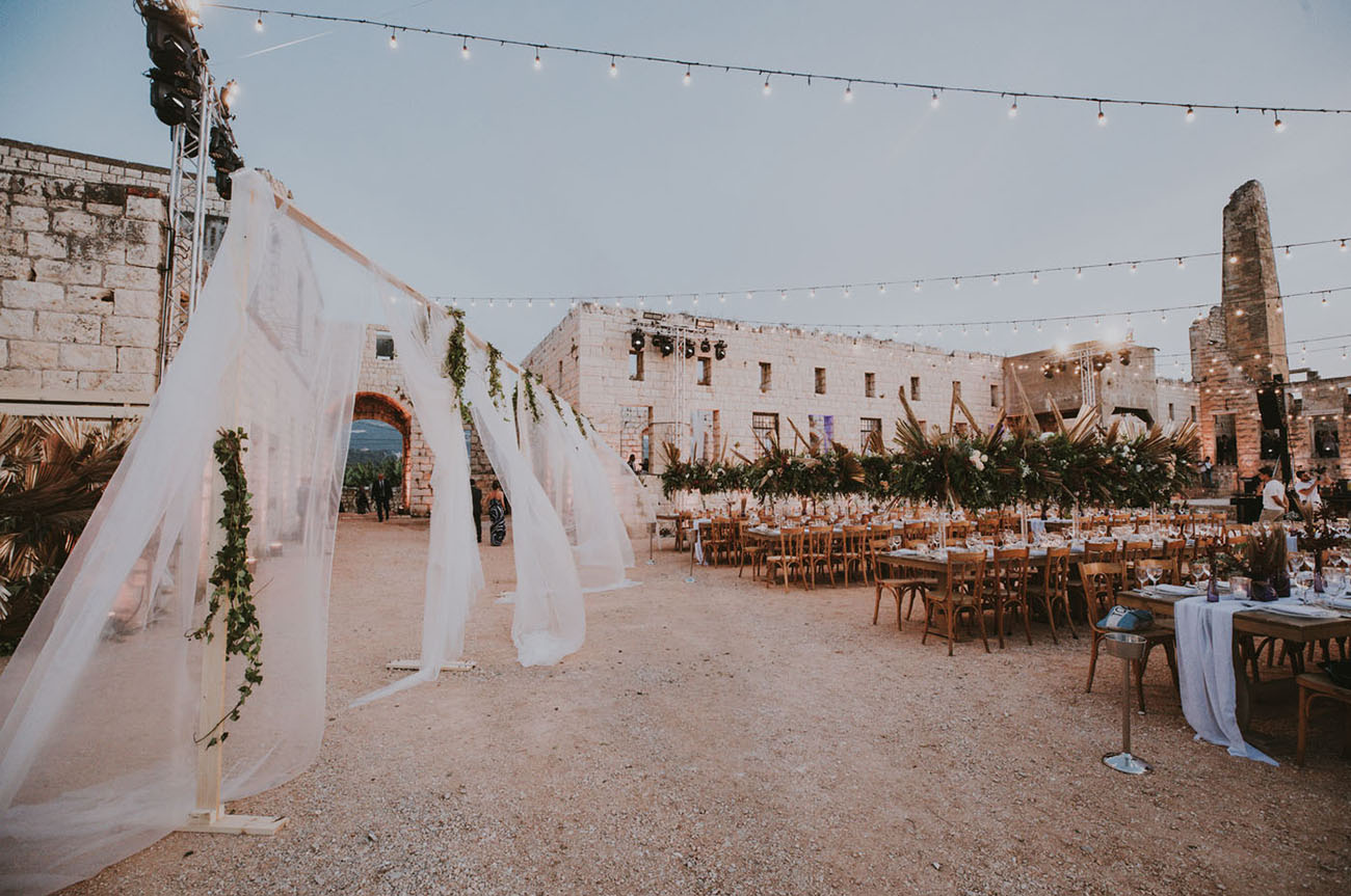 The reception took place under the stars and was decorated with greenery and fronds, too