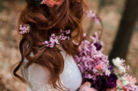 06 The wavy and relaxed wedding hairstyle was spruced up with purple and orange blooms