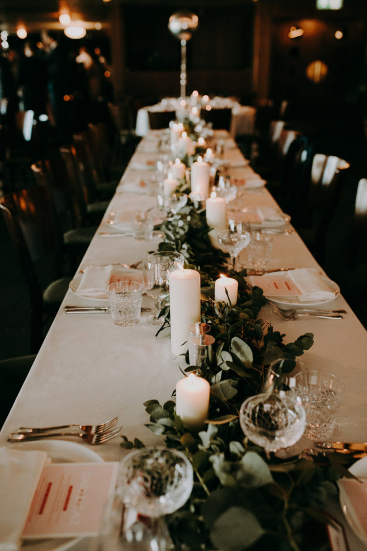 The tablescapes were done in neutrals, with fresh greenery and pillar candles to create a mood