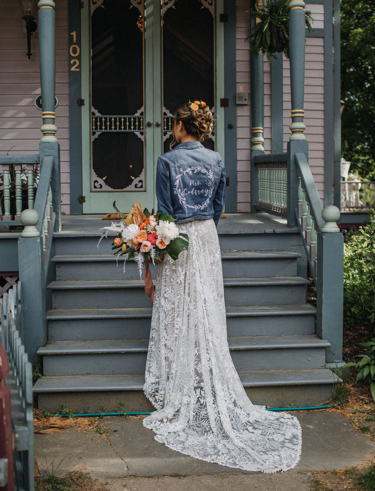 The bride covered up with a blue denim jacket that was personalized for her