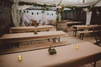 08 The wedding reception was done with much greenery, succulent terrarium centerpieces, candles and kraft paper