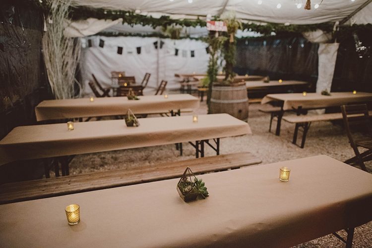 The wedding reception was done with much greenery, succulent terrarium centerpieces, candles and kraft paper