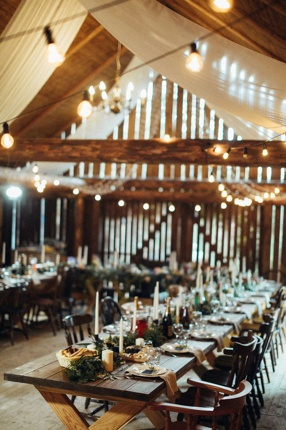 The wedding reception was inside the barn, with lots of lights, candles, greenery and uncovered tables for a rustic feel