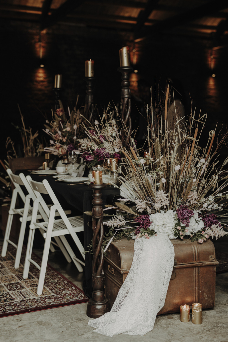 The wedding venue was decorated with pink blooms, dried herbs and leaves and dark candles