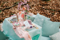 08 There was a picnic setting in pastels created for the couple, with lots of pillows, blooms and candles