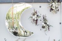 08 a beautiful wedding backdrop with a shiny silver moon, lush florals and dark and dried herbs and leaves