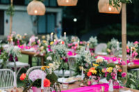 The tablescapes were decorated with neon pink runners, bright blooms and touches of gold