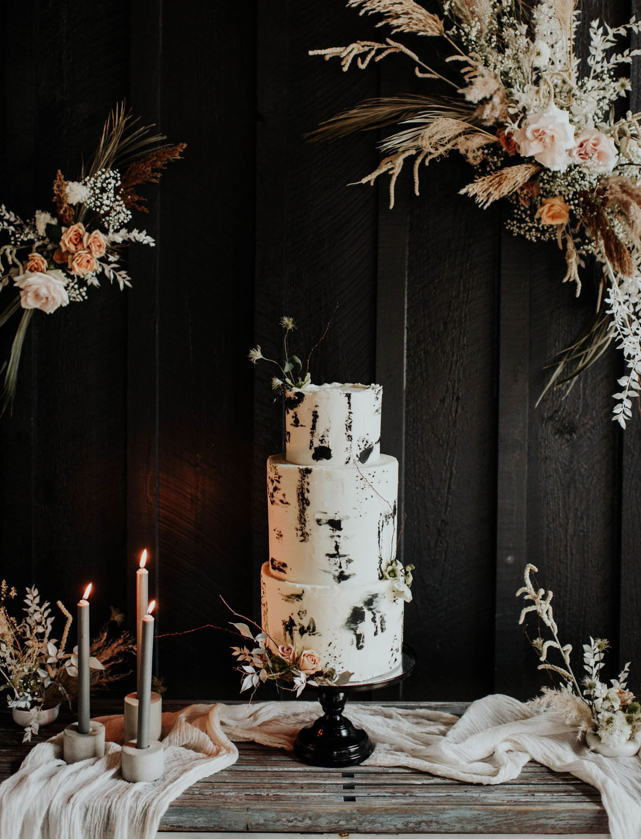 The wedding cake was white, with black brushstrokes and some dried blooms on top