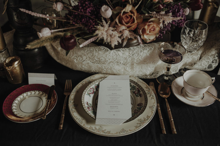 The wedding tablescape was a combo of elegant porcleain, gilded touchesm candles and fantastic florals