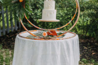 10 The wedding cake was displayed in an original way, it was floating in the copper rings decorated with fronds and blooms