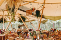 11 The teepee was decorated in a bold boho way, with overhead decor, lights, colored glasses and blooms