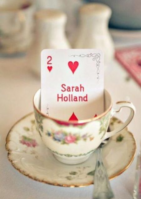 a vintage teacup with a place card to mark each place setting – great for Alice In Wonderland wedding