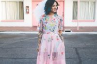 18 a badass bride wearing a pink wedding dress with colorful floral appliques, bow shoes and teal hair