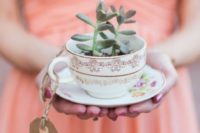 18 a floral teacup with potted succulents and a cardboard tag as a favor and place card