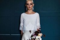22 a modern bridal look with a white top with lace trim and an off white silk skirt plus statement earrings that accent the hair color