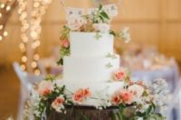 23 a beautiful wedding cake surrounded with LOVE cups with blooms is a very cute idea of displaying your cake