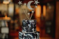 24 a dark watercolor wedding cake topped with silver glitter stars and moon on a shiny silver stand