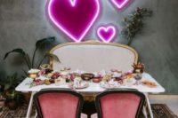 24 a wedding reception table with a pretty neon pink heart backdrop is a modenr take on classics